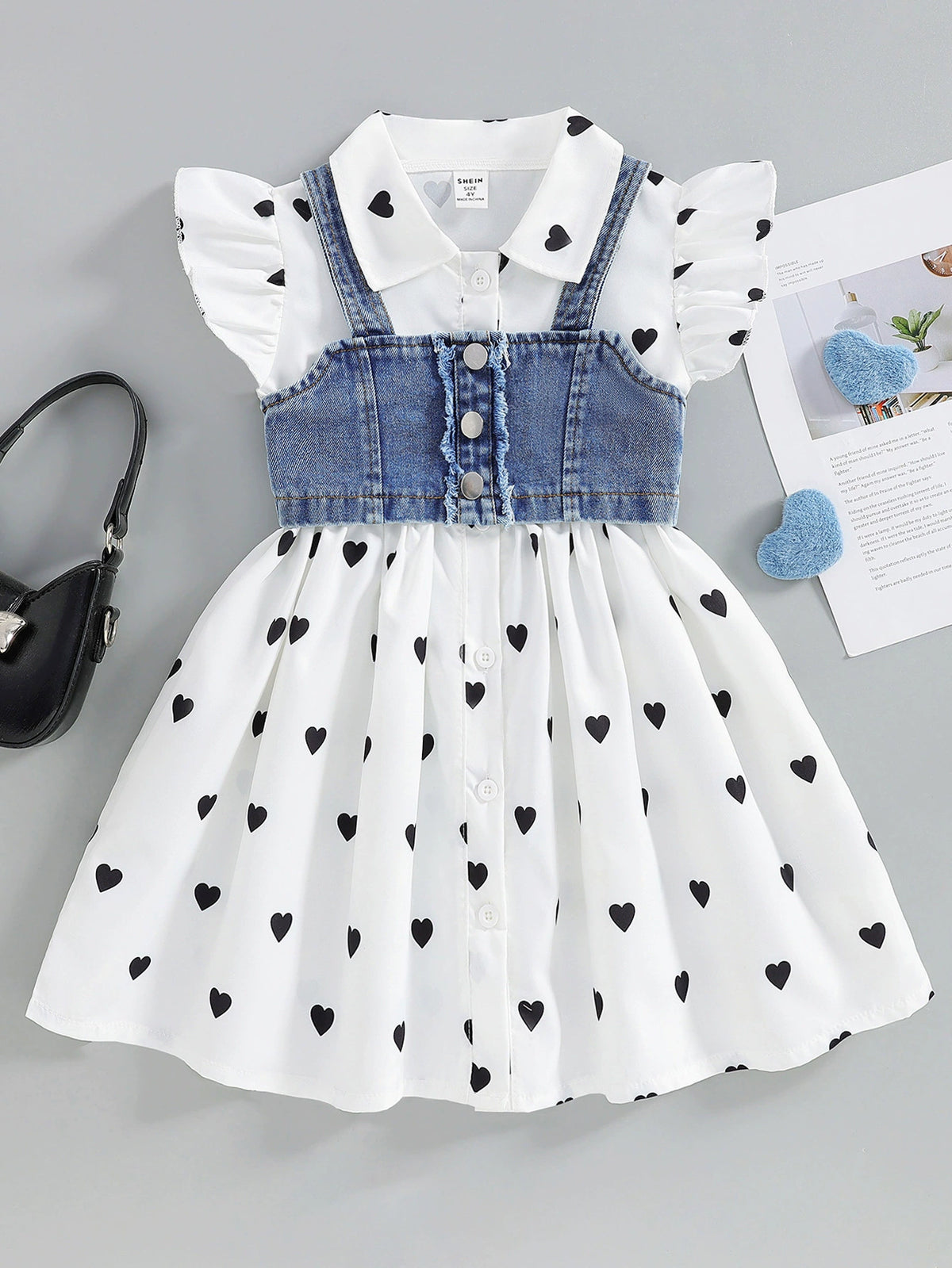 Baby dress with heart print, denim cami overlay, button front, short flutter sleeves.