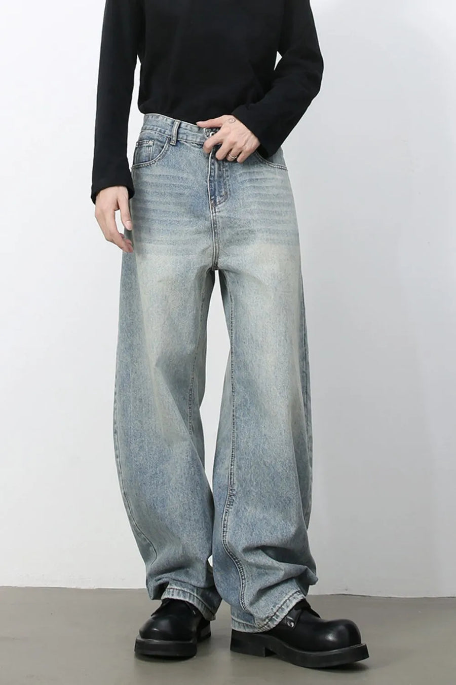 Faded light blue baggy denim jeans with a relaxed fit and wide leg.