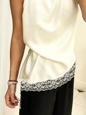 Ivory cami top with asymmetrical lace trim detail