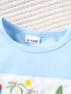 Pastel blue baby t-shirt with embroidered palm trees and sun detail.