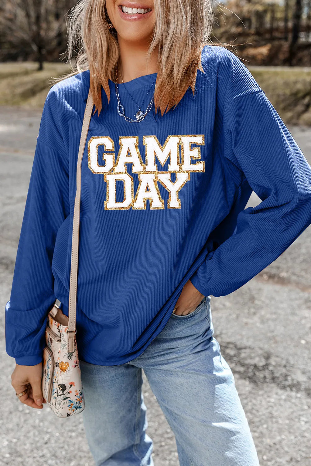 Peacock blue ribbed graphic sweatshirt with "GAME DAY" text, crewneck, and long sleeves.