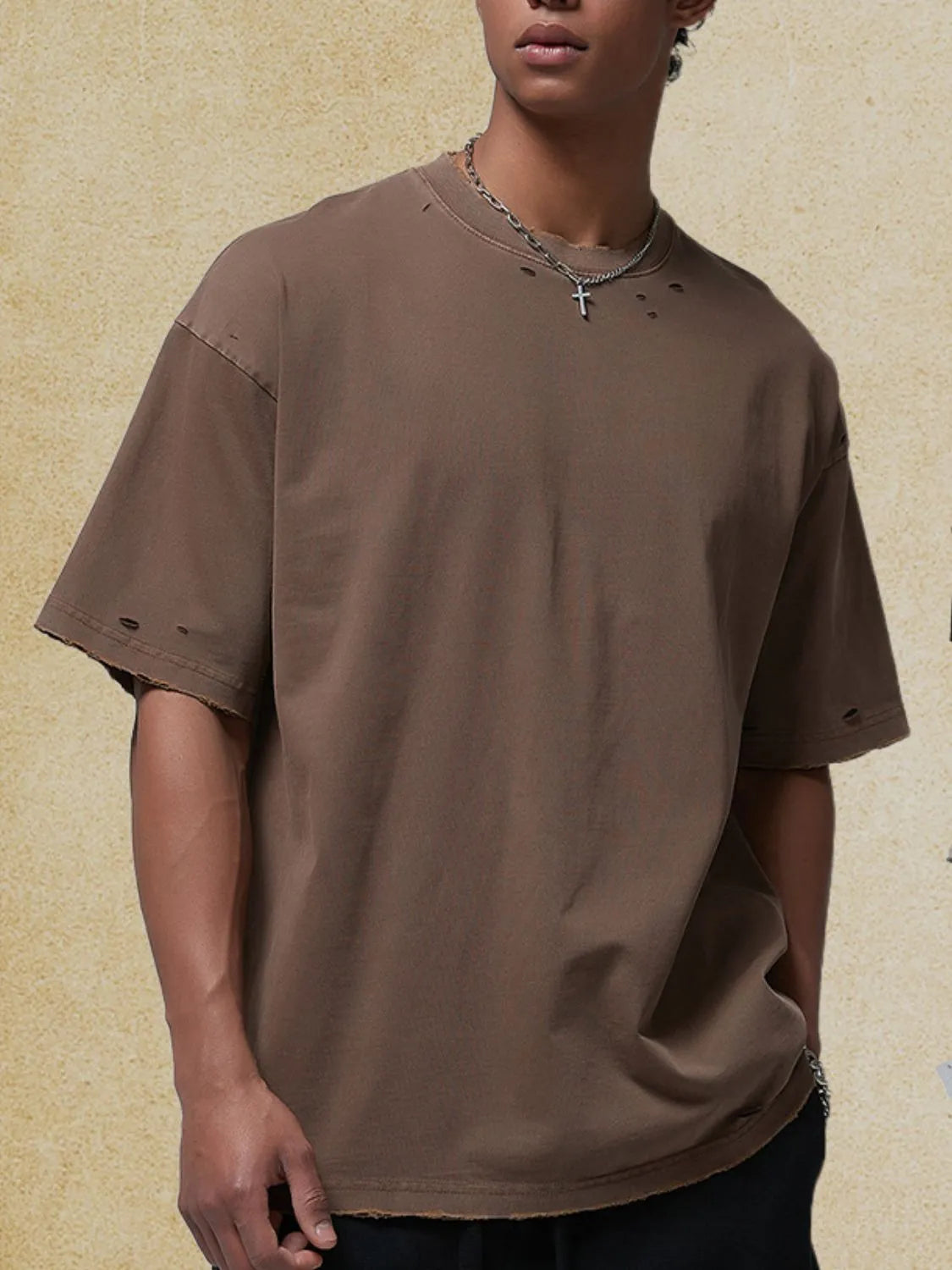 Distressed oversized cotton tee in coffee brown with raw hem and ripped details.
