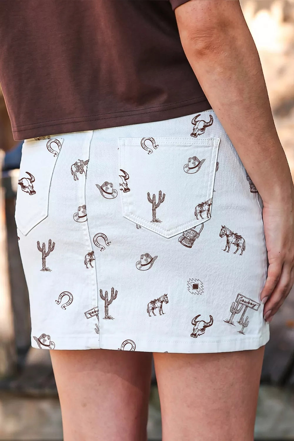 White mini skirt featuring pocketed and western-print