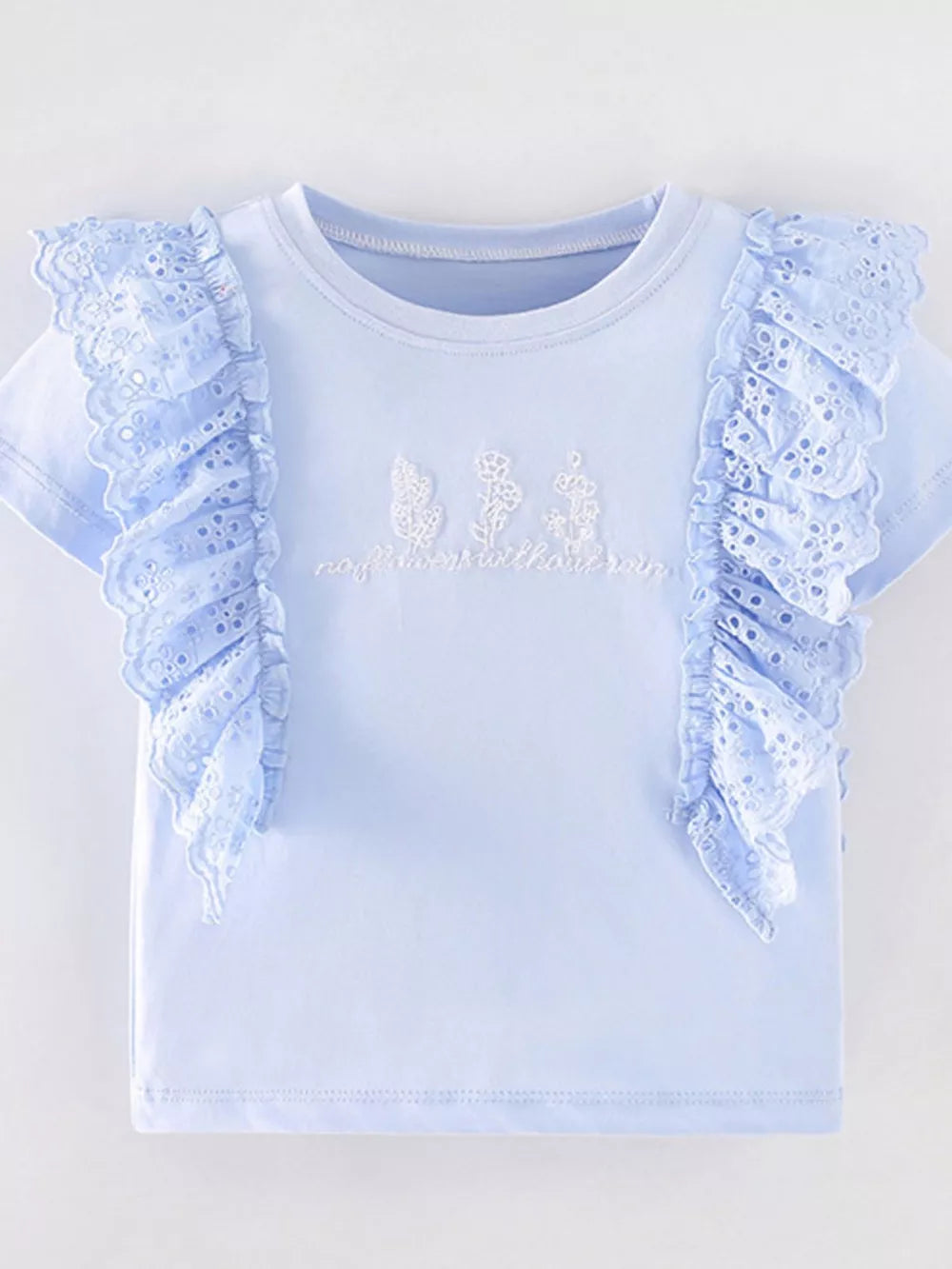 Light blue cotton t-shirt with eyelet ruffles and floral embroidery.