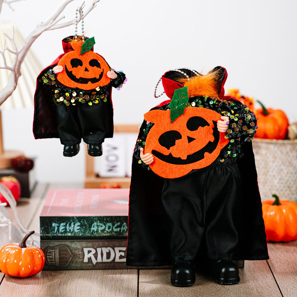 Halloween sequin cape doll with pumpkin face and black pants.