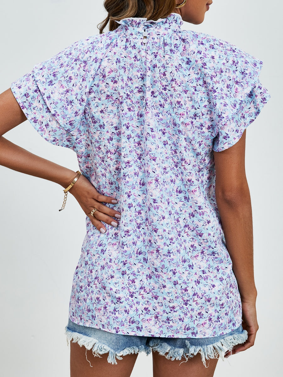 Light blue floral blouse with ruffled neckline and flutter sleeves