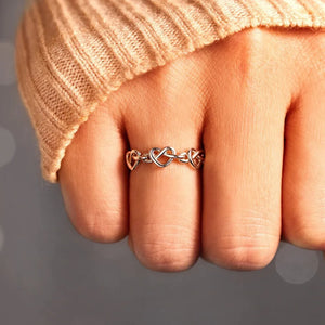 Sterling silver ring with intertwined heart motif, delicate and classic design.