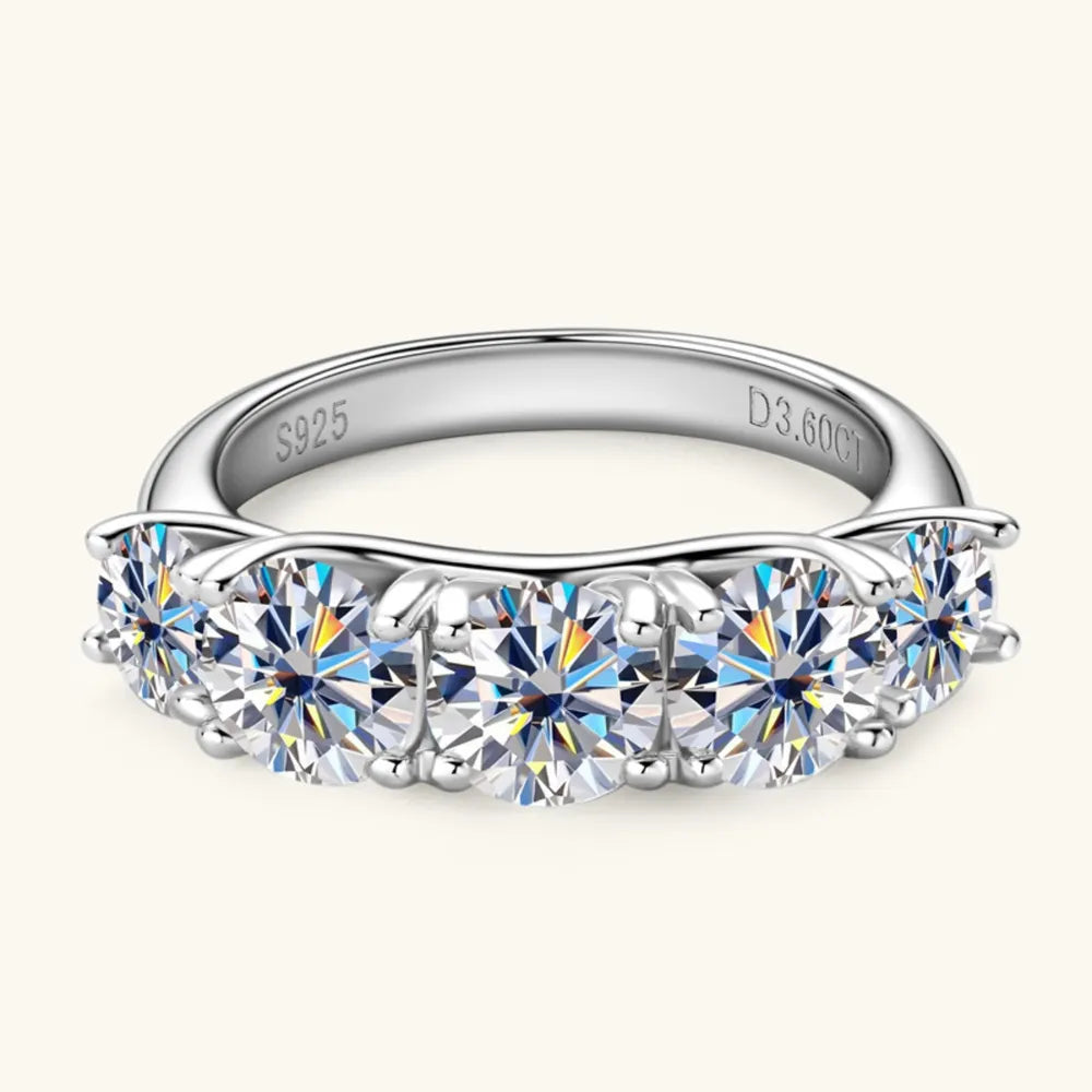 Silver band ring with five round moissanite stones and S925 engraving.