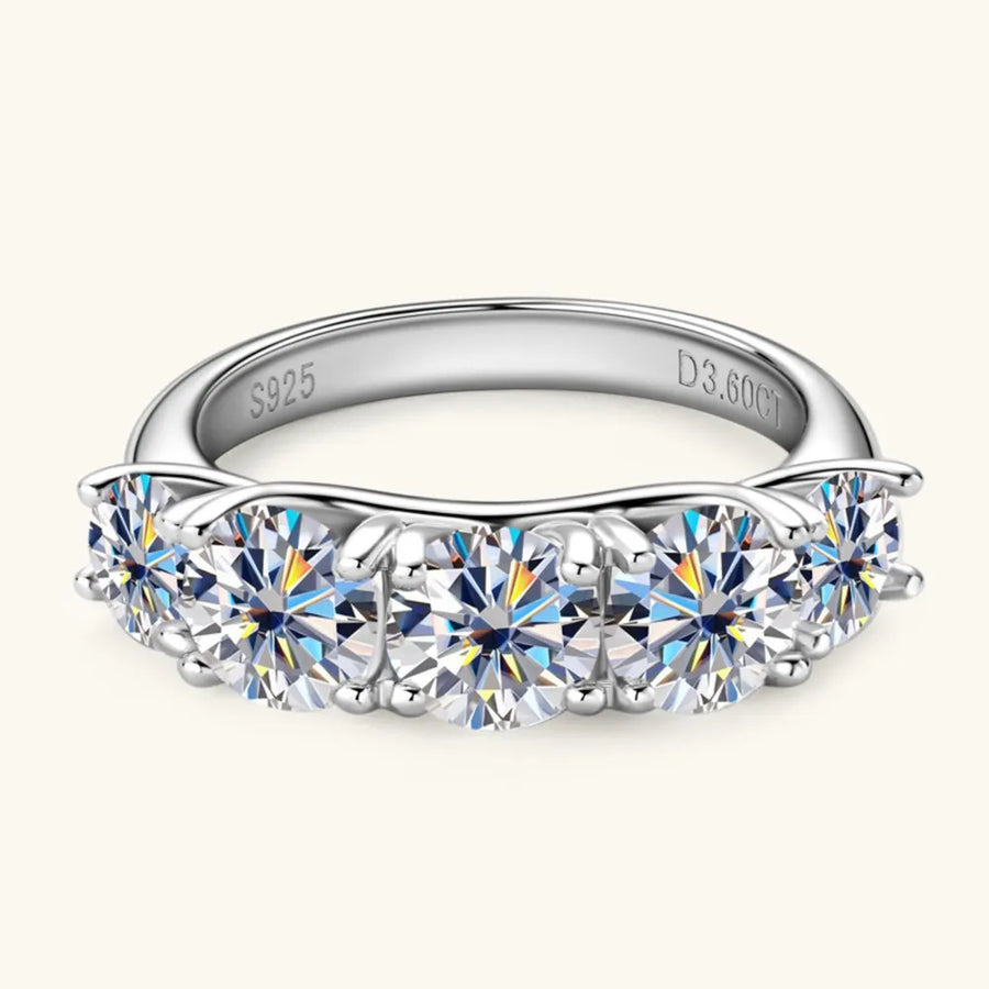 Silver band ring with five round moissanite stones and S925 engraving.