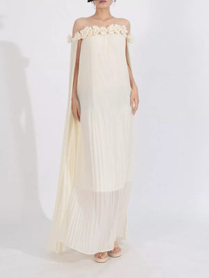 Elegant off-shoulder maxi dress in cream with floral appliques and cape sleeves.