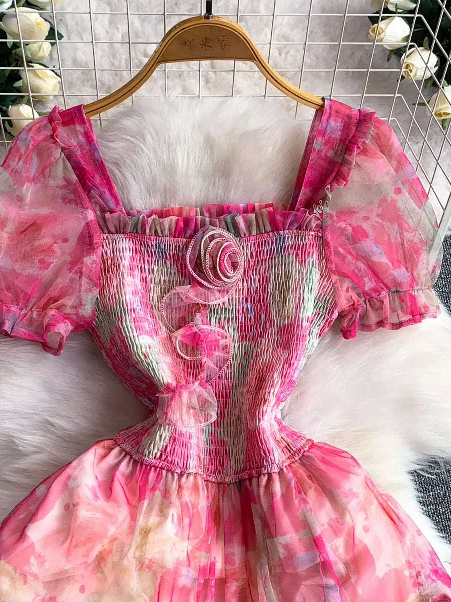 Floral tiered midi dress in pink with smocked bodice and puff sleeves.
