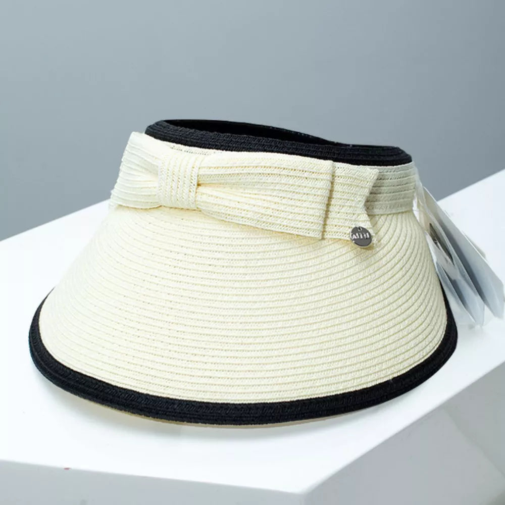 Ivory white straw sun visor hat with black trim and a decorative bowknot detail.