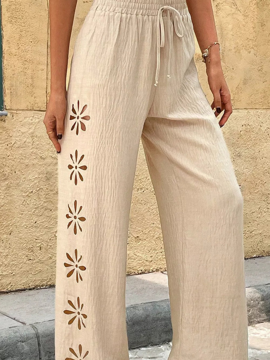 Beige linen blend wide leg pants with floral cutouts and drawstring waist