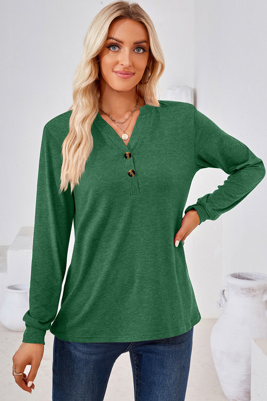 Dark green Henley button-down knit top with a V-neck and two brown buttons.