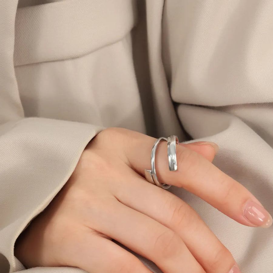 Silver sculptural spiral steel ring with a modern, minimalist design.