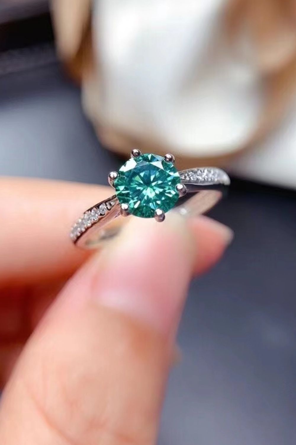 Teal moissanite solitaire ring with pave diamond band in silver.