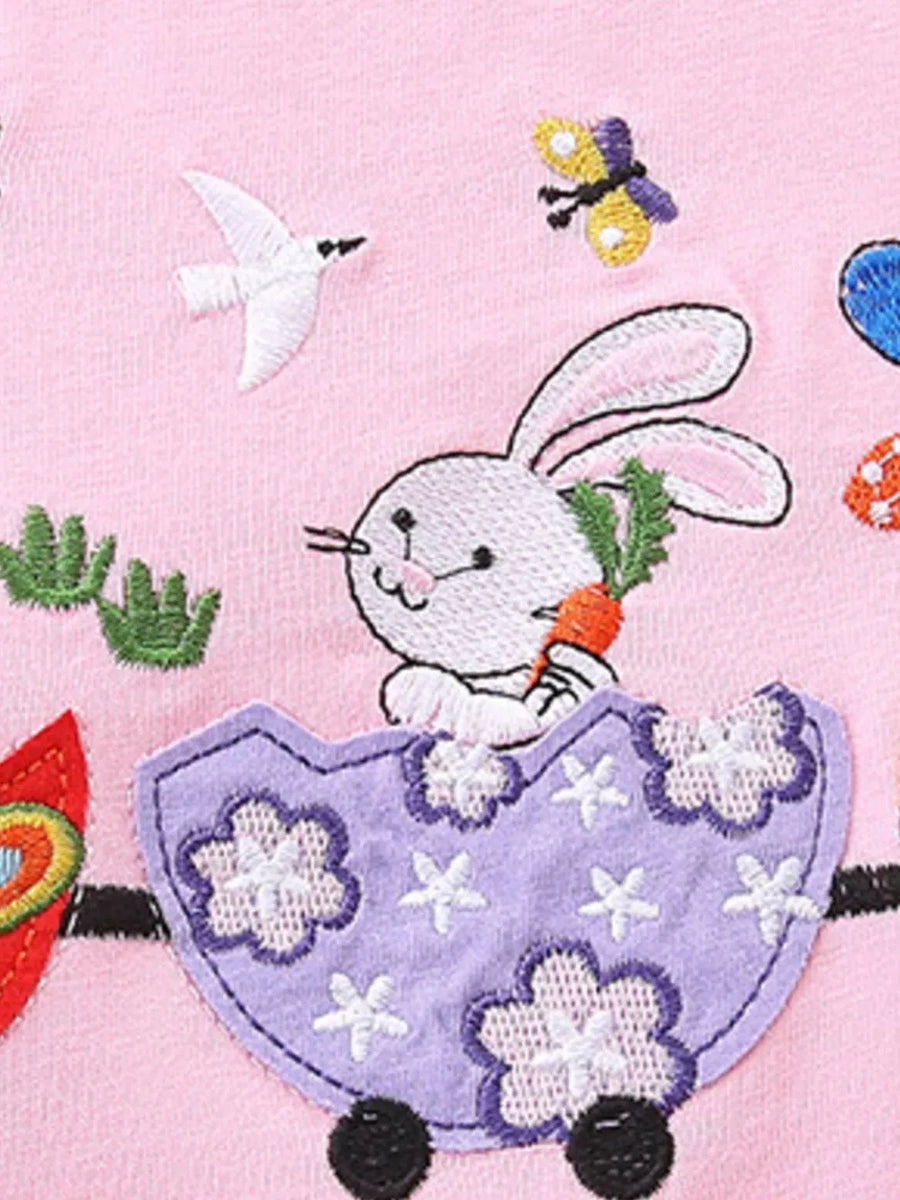 Pink cotton baby top with embroidered bunny train, butterfly, and bird details.