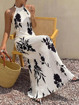Ivory and black floral print halter neck maxi dress with pleats.