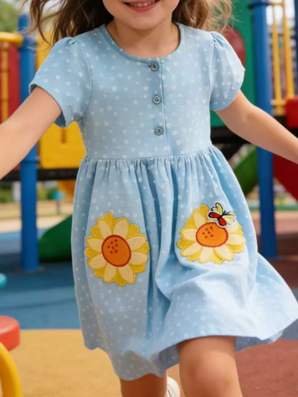 Light blue polka dot toddler dress with embroidered sunflowers and butterfly appliques.
