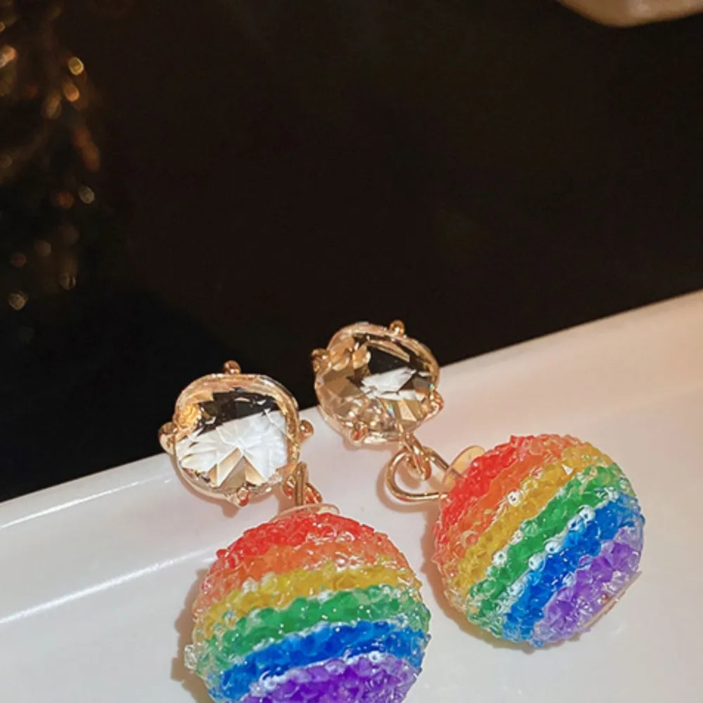 Rainbow orb crystal drop earrings with faceted clear gems and rainbow colored beaded spheres.