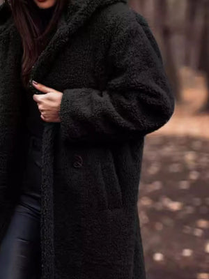 Black teddy bear longline coat with button closure and hooded detail.