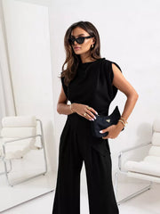 Black satin cowl neck two-piece set with wide leg pants and sleeveless top.