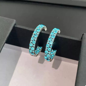Sparkling pastel blue hoop earrings with two rows of rhinestones.