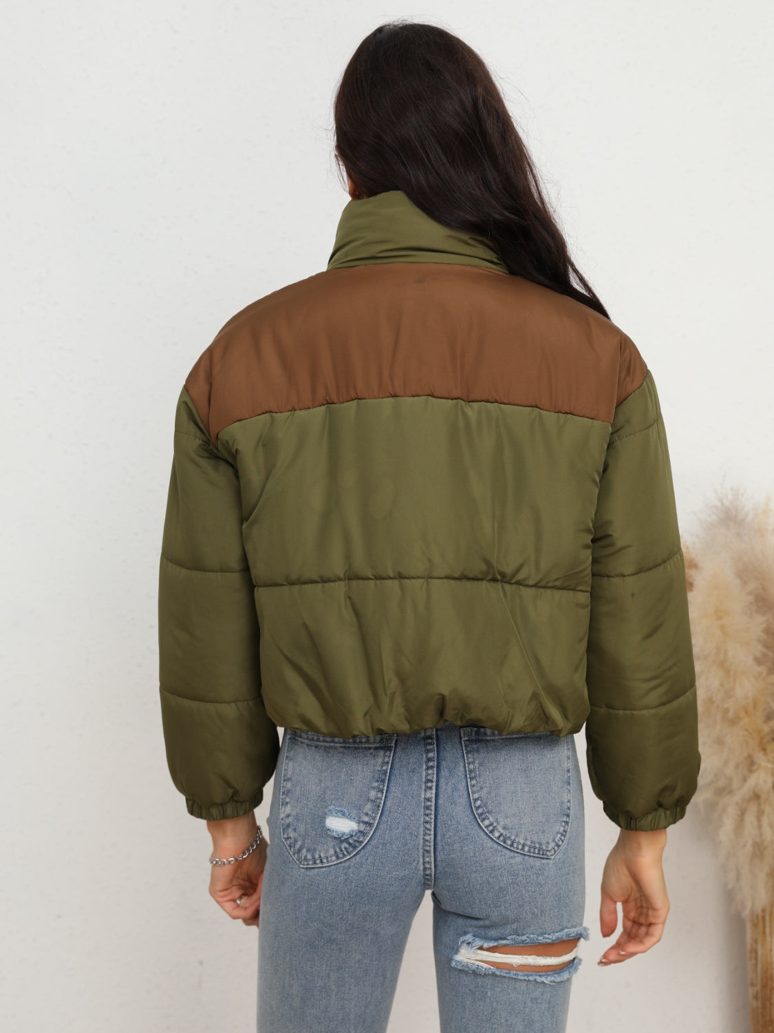 Colorblock cropped puffer jacket in army green with brown accents, featuring a stand-up collar and quilted design.
