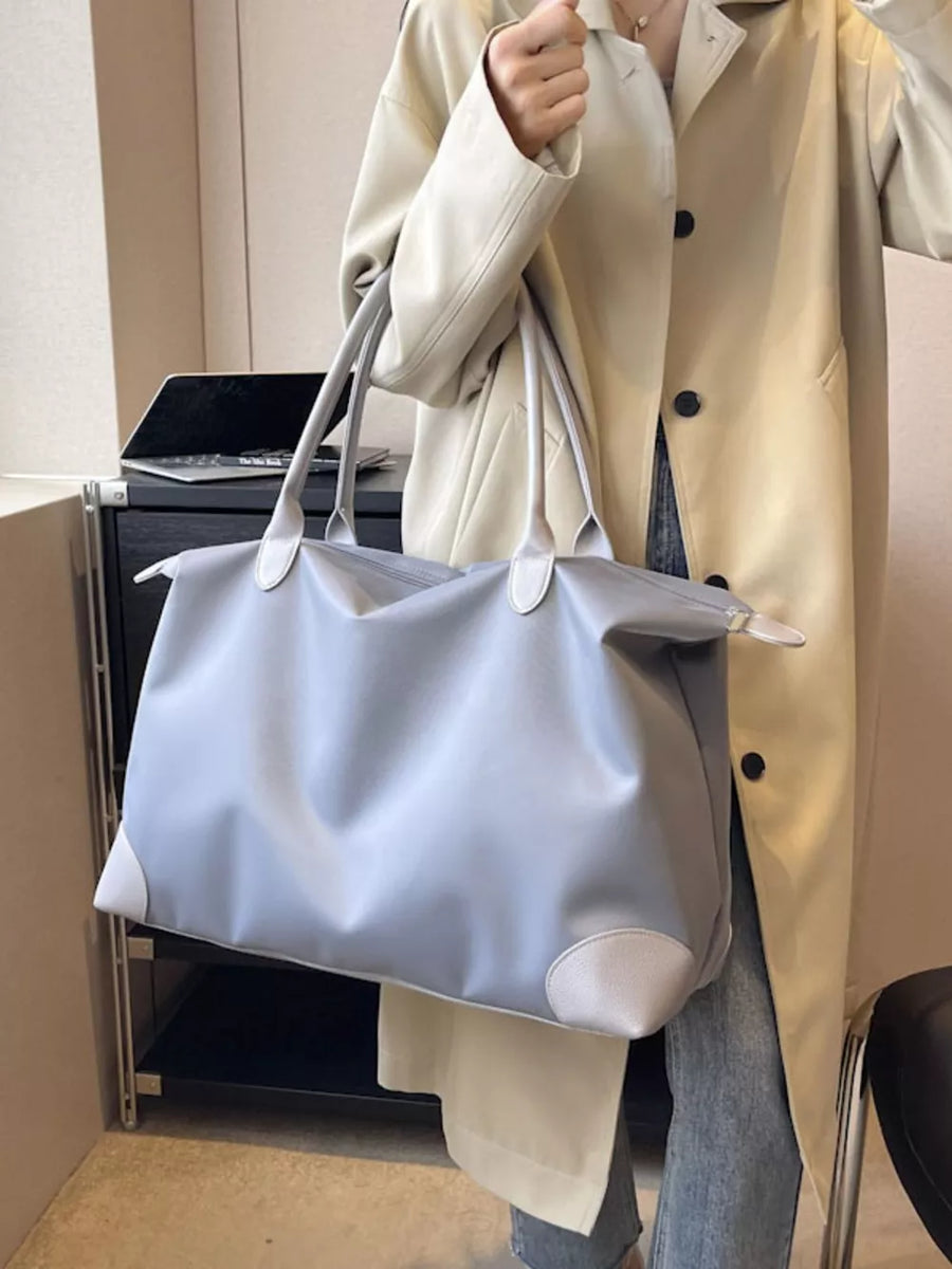 Grey Oxford cloth travel tote bag with light grey trim and handles.