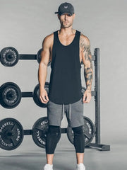 Black scoop neck muscle tank top with a curved hem.