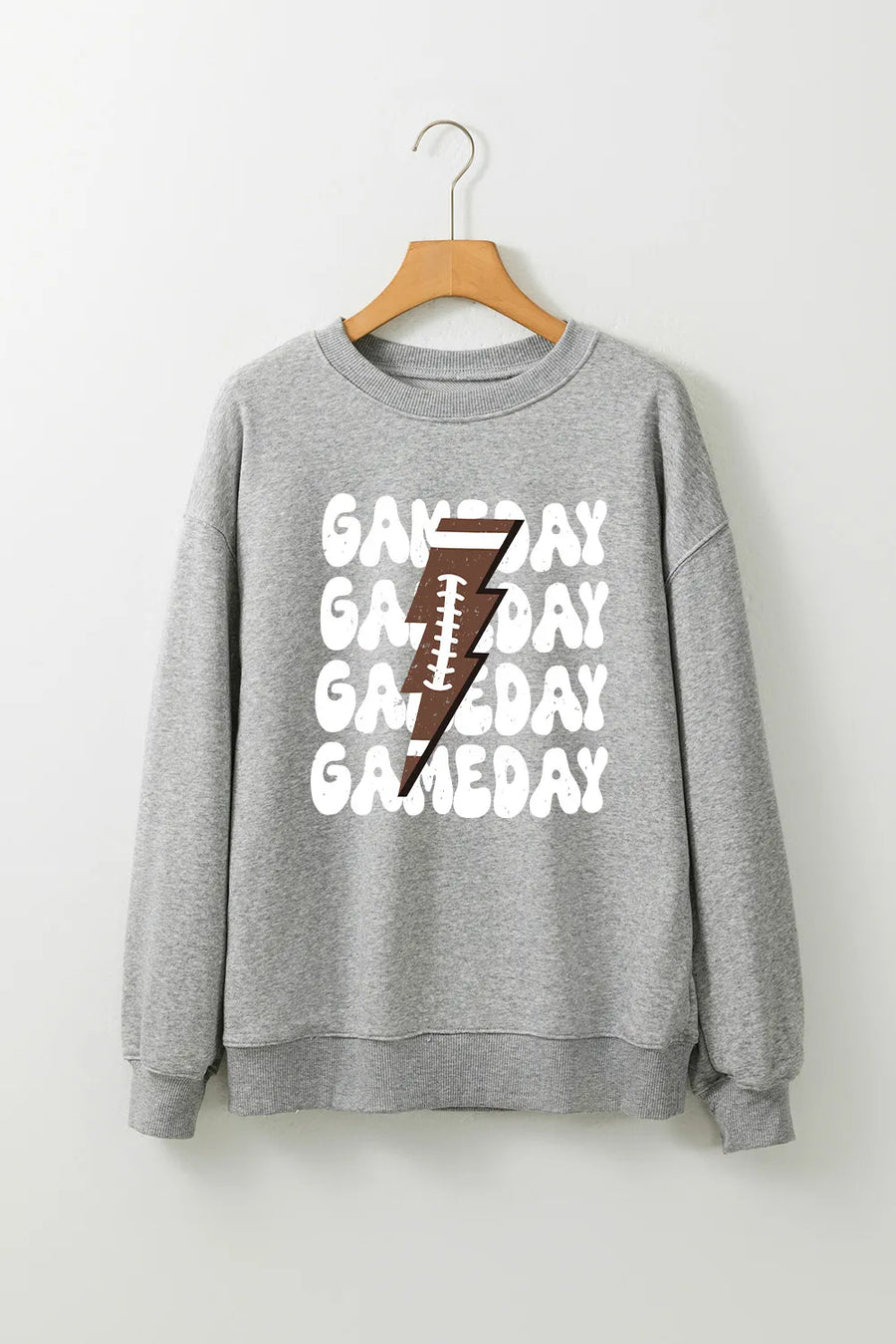 Gray sweatshirt with repeating "Gameday" text and a football lightning bolt graphic.