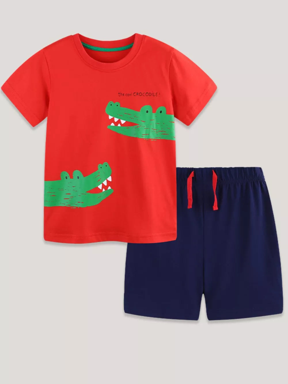 Red cotton blend toddler t-shirt with green crocodile print and navy shorts.