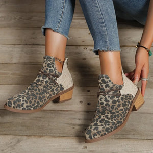Leopard print ankle boots with cutout sides, chain detail, and block heel.