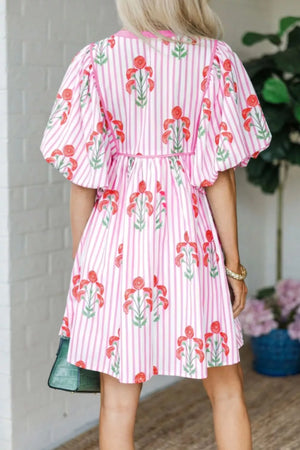 Floral stripe mini dress in blush pink with puff sleeves and tie detail.