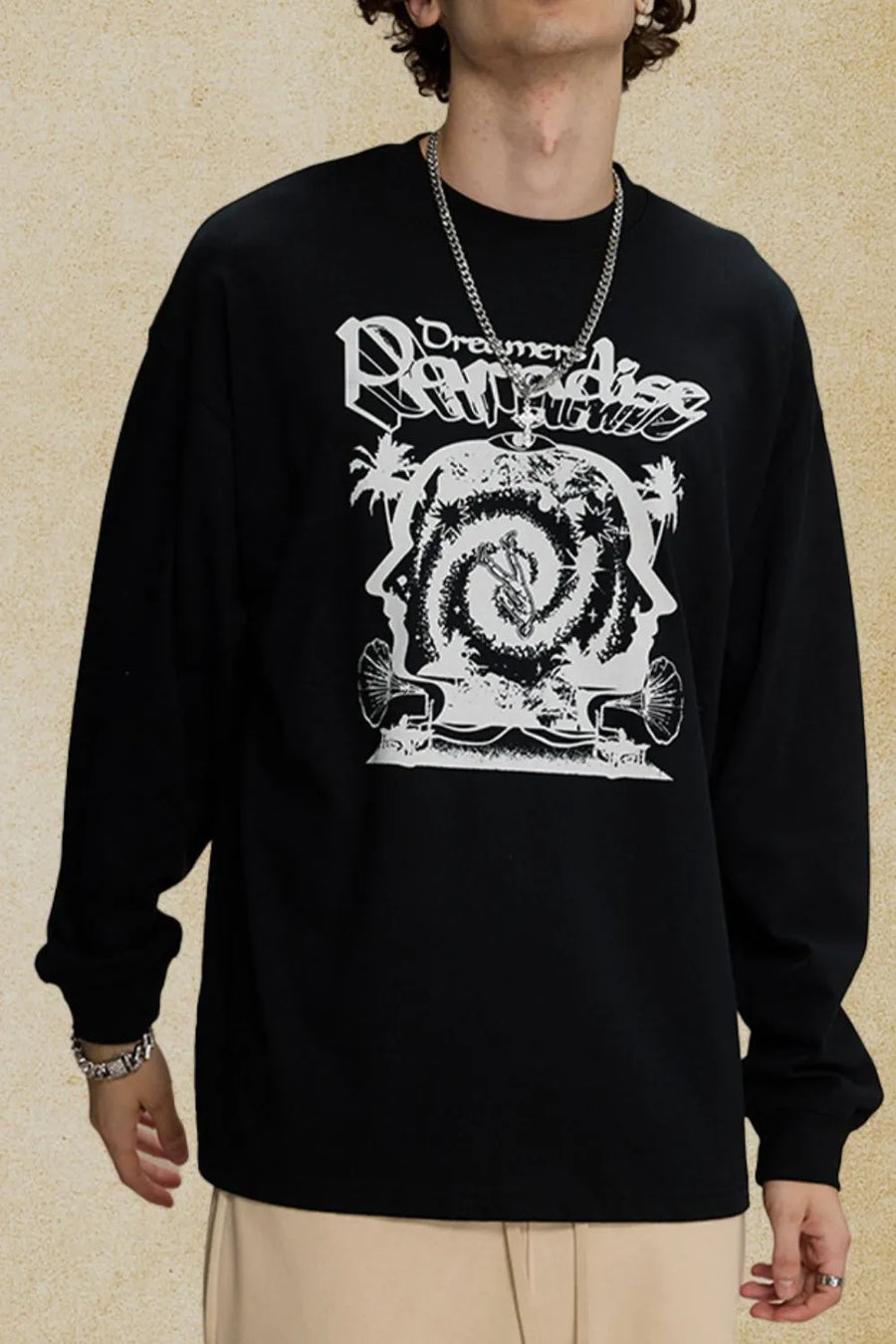 Black long sleeve graphic tee with bold white "Dreamers Paradise" print and abstract design.