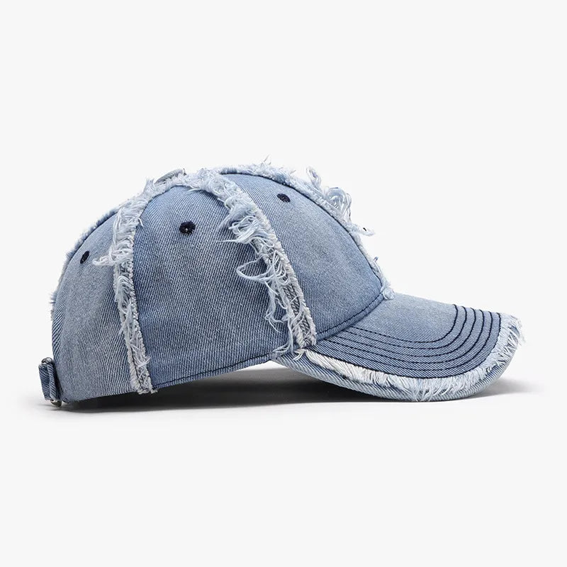 Distressed denim baseball cap with frayed details in light blue.