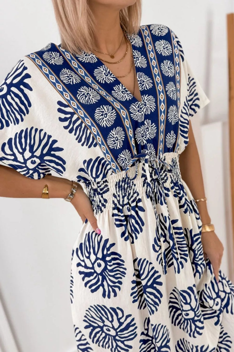 Blue floral print V-neck dolman dress with smocked waist and tie detail