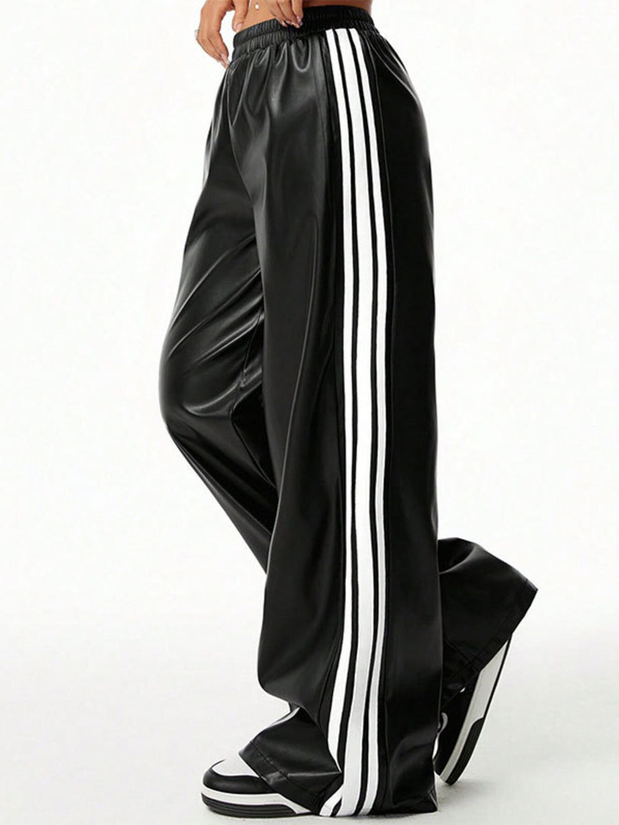 Black faux leather wide leg track pants with white side stripes and elastic waistband.