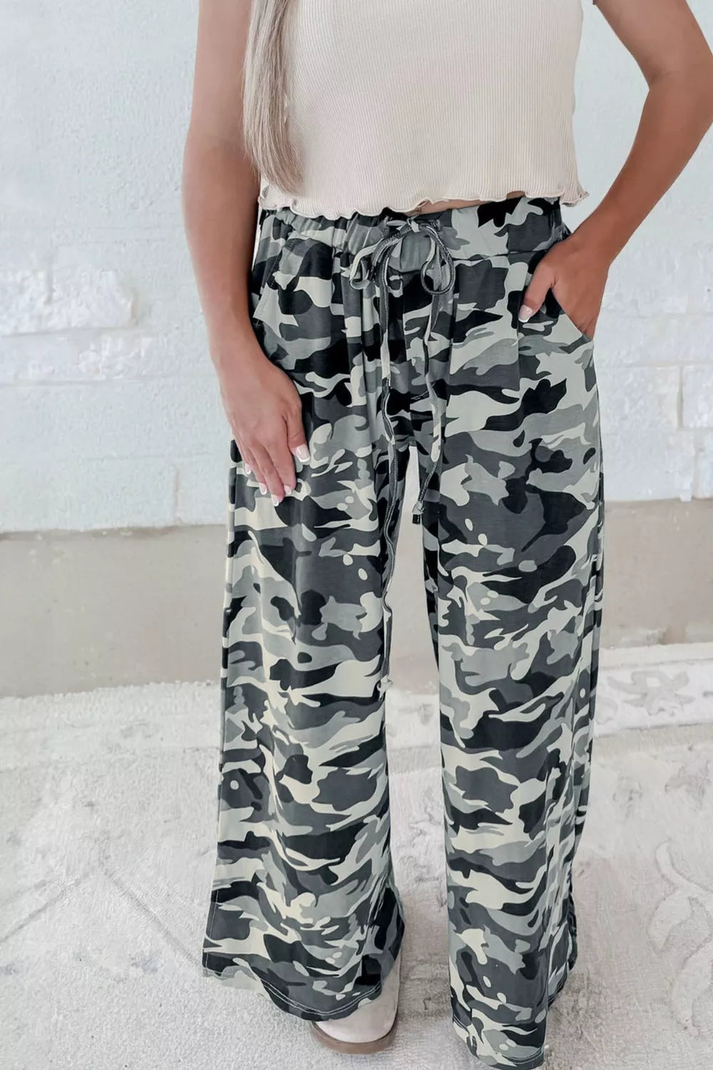 Casual camouflage drawstring waist pants with pockets and wide legs.