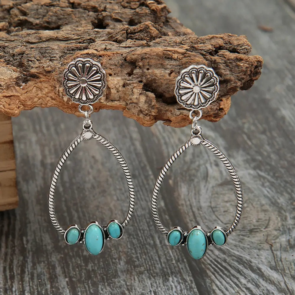Southwestern teardrop earrings with turquoise stones and alloy metal detail.