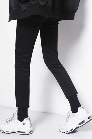 Men's black skinny jeans with raw hem detail