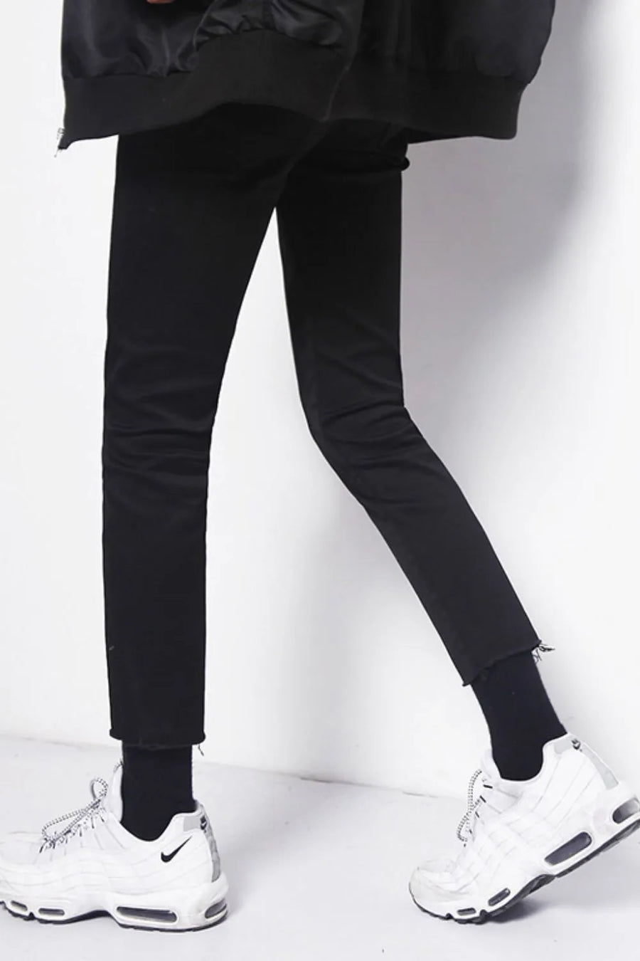 Men's black skinny jeans with raw hem detail