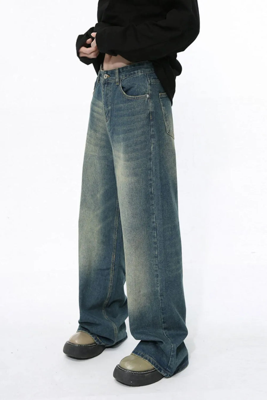Faded wash wide-leg jeans in medium blue denim with a relaxed fit.