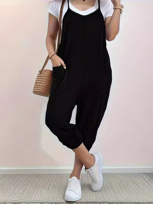 Black loose fit spaghetti strap jumpsuit with pockets and cuffed ankles.