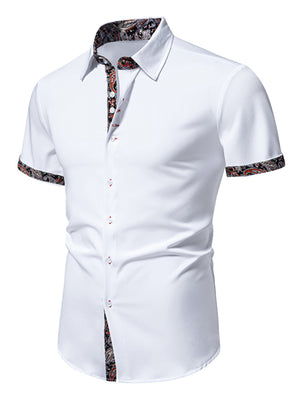 White short sleeve buttoned shirt with paisley trim on collar, cuffs, and placket.