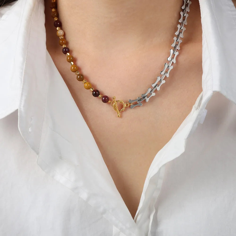 Silver asymmetrical bead and bone chain necklace with toggle clasp