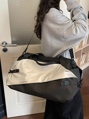 Oxford cloth travel bag in black and silver with dual handles and shoulder strap.