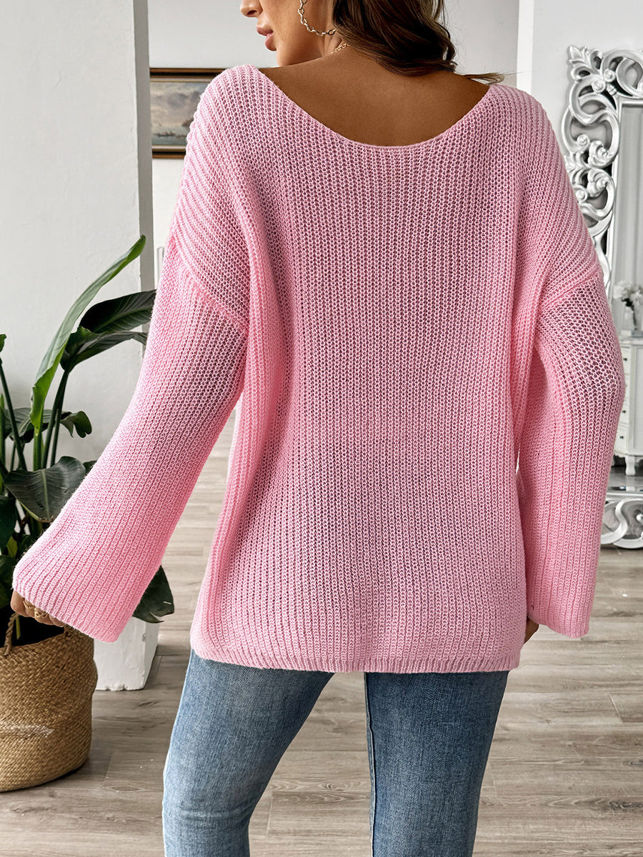 Blush pink knit sweater with boatneck and long sleeves, featuring a textured knit pattern.