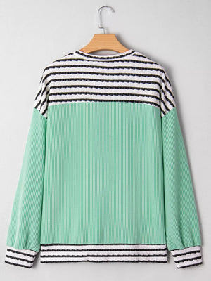 Turquoise long-sleeve top with horizontal stripes on the yoke and cuffs, and a ribbed texture.