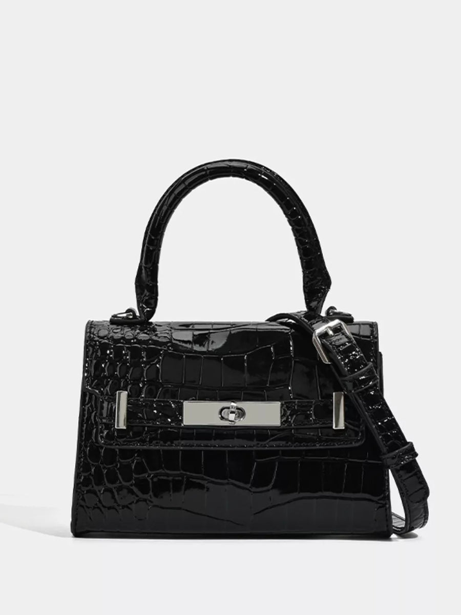 Black croc-embossed small tote bag with silver hardware and adjustable strap.
